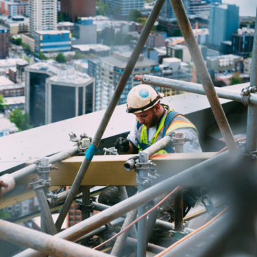 Man working in scaffold on a skyscraper