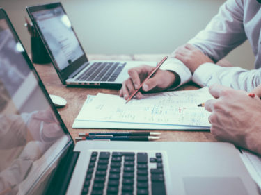 business papers and two laptops