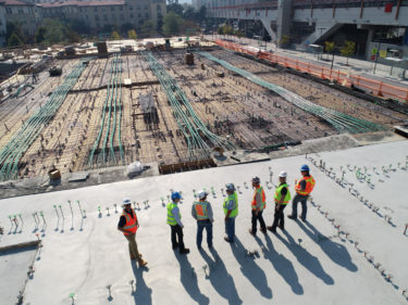 men standing on concrete slab