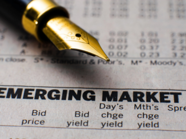A pen on newspaper which reads emerging market