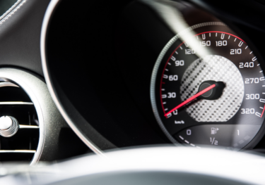 Speedometer close up which symbolizes automotive industry