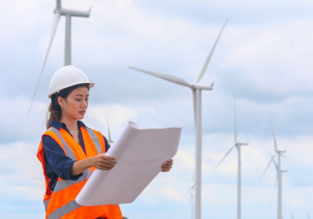 A planner standing in front of wind farms