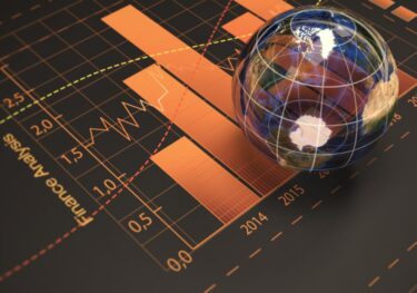 A globe against financial chart background, symbolising global economy paradigm shifts over decades