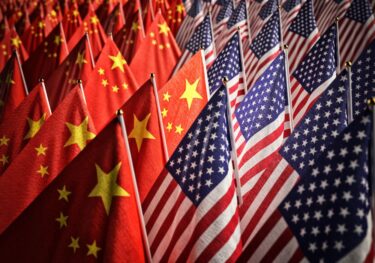 China and US flags, trade war and trade deals