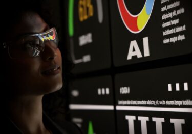 AI Using. Silhouetted analysts interact with a large AI data